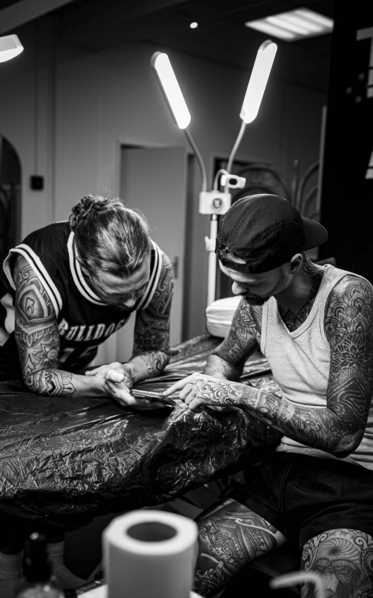 Black and white shot of JB reviewing a design with a client